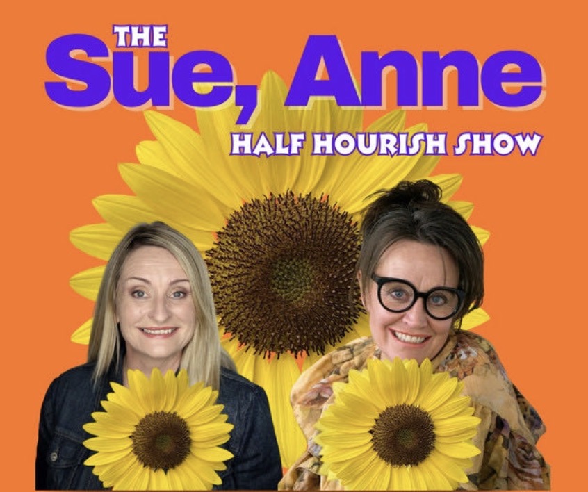 The Sue, Anne Half Hourish Show artwork: Sue Collins and Anne Gildea in front of a giant sunflower on an orange background